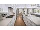 Modern kitchen with white cabinets, herringbone backsplash, and gas cooktop at 613 Stone Field Nw Run, Marietta, GA 30060