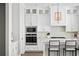 White kitchen with stainless steel appliances and herringbone backsplash at 613 Stone Field Nw Run, Marietta, GA 30060