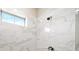 Clean shower with marble tile and a window at 613 Stone Field Nw Run, Marietta, GA 30060