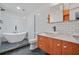 Modern bathroom with a freestanding soaking tub, double vanity, and hexagon tile at 1816 Evans Dr, Atlanta, GA 30310