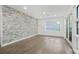 Bright living room featuring wood floors and stone accent wall at 1816 Evans Dr, Atlanta, GA 30310