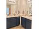 Double vanity bathroom with dark cabinetry and neutral countertops at 2169 Olmadison Vw, Atlanta, GA 30349