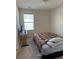 Bright bedroom with a double bed, window and carpeted floor at 2169 Olmadison Vw, Atlanta, GA 30349