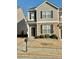 Two-story townhome with neutral siding, black shutters, and a small front yard at 2169 Olmadison Vw, Atlanta, GA 30349