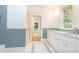 Modern bathroom with double vanity, marble countertop, and blue tile at 2624 Forrest Ne Way, Atlanta, GA 30305