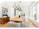 Bright dining room features a large wooden table, chandelier, and hardwood floors at 2624 Forrest Ne Way, Atlanta, GA 30305