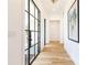 Light and airy entryway with a modern black framed glass door and hardwood floors at 2624 Forrest Ne Way, Atlanta, GA 30305