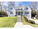 Beautiful two-story home with gray siding, manicured lawn, and a welcoming front porch at 2624 Forrest Ne Way, Atlanta, GA 30305