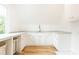 Laundry room with white cabinets, marble countertop, and a window at 2624 Forrest Ne Way, Atlanta, GA 30305