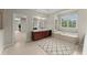 Elegant bathroom with soaking tub, double vanity, and separate shower at 4562 Worthings Dr, Powder Springs, GA 30127