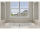 Luxurious bathroom with large garden tub and double windows at 4562 Worthings Dr, Powder Springs, GA 30127