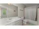 Bathroom with shower/tub combo, vanity, and neutral decor at 4562 Worthings Dr, Powder Springs, GA 30127