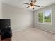 Well-lit bedroom with ceiling fan and neutral-toned carpet at 4562 Worthings Dr, Powder Springs, GA 30127