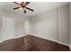 Bright bedroom with ceiling fan, hardwood floors and access to a bathroom at 4562 Worthings Dr, Powder Springs, GA 30127