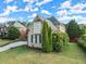 Brick house with a dormer window and landscaping at 4562 Worthings Dr, Powder Springs, GA 30127