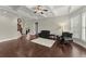 Living room with hardwood floors and multiple seating areas at 4562 Worthings Dr, Powder Springs, GA 30127