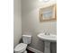 Convenient powder room with pedestal sink and dark hardwood floor at 4562 Worthings Dr, Powder Springs, GA 30127