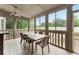 Relaxing screened porch with outdoor seating and ceiling fan at 4562 Worthings Dr, Powder Springs, GA 30127