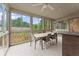 Screened porch features a table and chairs, perfect for dining outdoors at 4562 Worthings Dr, Powder Springs, GA 30127