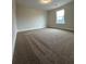 Bright bedroom with neutral carpet and a light-filled window at 11204 Cornerstone Way, Lovejoy, GA 30228