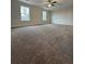 Spacious main bedroom with ceiling fan and natural light from two windows at 11204 Cornerstone Way, Lovejoy, GA 30228