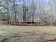 Mobile home nestled in a wooded setting with a clear yard at 337 Theodore Cox Cir, Canton, GA 30114