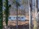 Single-story home nestled in a wooded area, offering privacy and tranquility at 337 Theodore Cox Cir, Canton, GA 30114