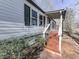 Covered porch with wooden stairs leading to the entrance at 337 Theodore Cox Cir, Canton, GA 30114