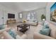 Spacious living room with light sofas and a large TV at 337 Theodore Cox Cir, Canton, GA 30114