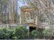 Wooden swing set under a pergola in the backyard at 337 Theodore Cox Cir, Canton, GA 30114