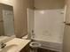 Bathroom with a shower/tub combo and white tile at 3763 Woodrose Ct, Snellville, GA 30039