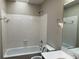 Clean bathroom with a bathtub, toilet, and vanity with mirror at 3763 Woodrose Ct, Snellville, GA 30039
