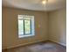Spacious bedroom with neutral walls and carpeting, featuring a large window at 3763 Woodrose Ct, Snellville, GA 30039