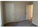 Well-lit bedroom featuring neutral walls, carpet, and a door to another room at 3763 Woodrose Ct, Snellville, GA 30039