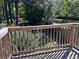 Wooden deck overlooking fenced backyard with mature trees at 3763 Woodrose Ct, Snellville, GA 30039