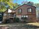 Two-story house with wood siding, stone accents, and a deck at 3763 Woodrose Ct, Snellville, GA 30039