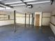 Two-car garage with storage shelving and access to stairs at 3763 Woodrose Ct, Snellville, GA 30039