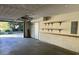 Spacious two-car garage with shelving and an open door at 3763 Woodrose Ct, Snellville, GA 30039