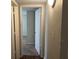 A hallway with doors to bedrooms and carpeted floors at 3763 Woodrose Ct, Snellville, GA 30039