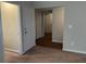 Hallway with wood flooring, neutral walls and doors to other rooms at 3763 Woodrose Ct, Snellville, GA 30039
