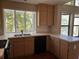 Kitchen with wood cabinets, double sink, and window at 3763 Woodrose Ct, Snellville, GA 30039