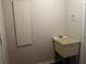 Laundry room with utility sink and fold-down ironing board at 3763 Woodrose Ct, Snellville, GA 30039