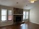 Living room with stone fireplace and hardwood floors at 3763 Woodrose Ct, Snellville, GA 30039