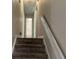 Upstairs hallway with carpeted stairs and doors to bedrooms and bath at 3763 Woodrose Ct, Snellville, GA 30039