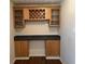 Built-in wet bar with wood cabinets and black tile counter at 3763 Woodrose Ct, Snellville, GA 30039