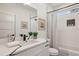 Modern bathroom with white cabinets, bathtub, and a walk-in shower at 1732 Beecher Sw St, Atlanta, GA 30310