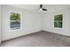 Spacious bedroom with grey carpet, ceiling fan and two windows offering natural light at 1732 Beecher Nw St, Atlanta, GA 30310