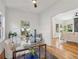 Bright dining area with glass table and hardwood floors, offering view to living room at 1732 Beecher Nw St, Atlanta, GA 30310