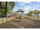 Two-story house with a large backyard, deck, and wooden fence at 1732 Beecher Sw St, Atlanta, GA 30310