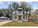 Two story farmhouse style home with a front porch and well manicured lawn at 1732 Beecher Sw St, Atlanta, GA 30310